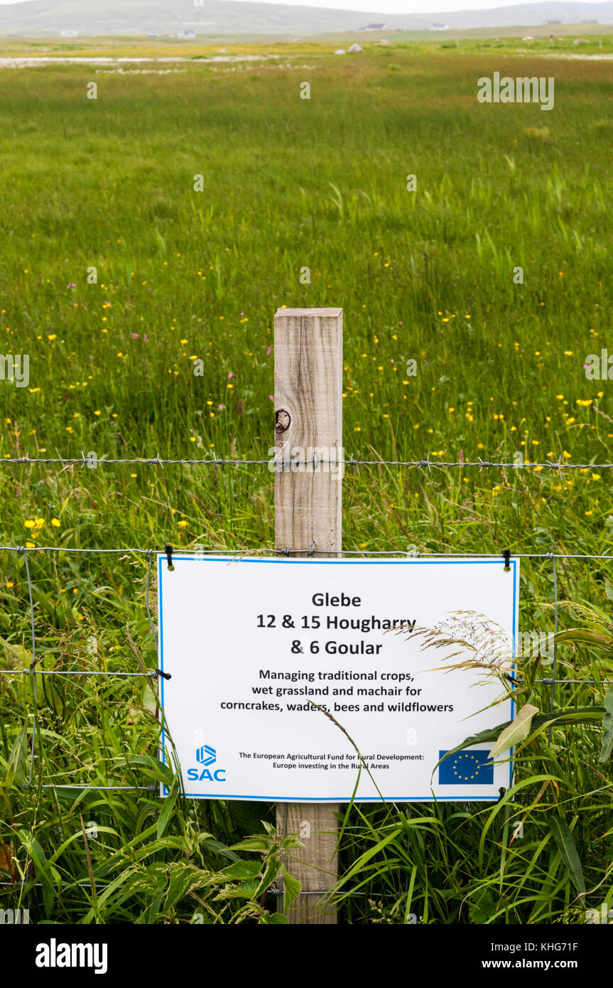 A sign on North Uist in the Outer Hebrides records investment by European Agricultural Fund for Rural Development in traditional land management. Stock Photo