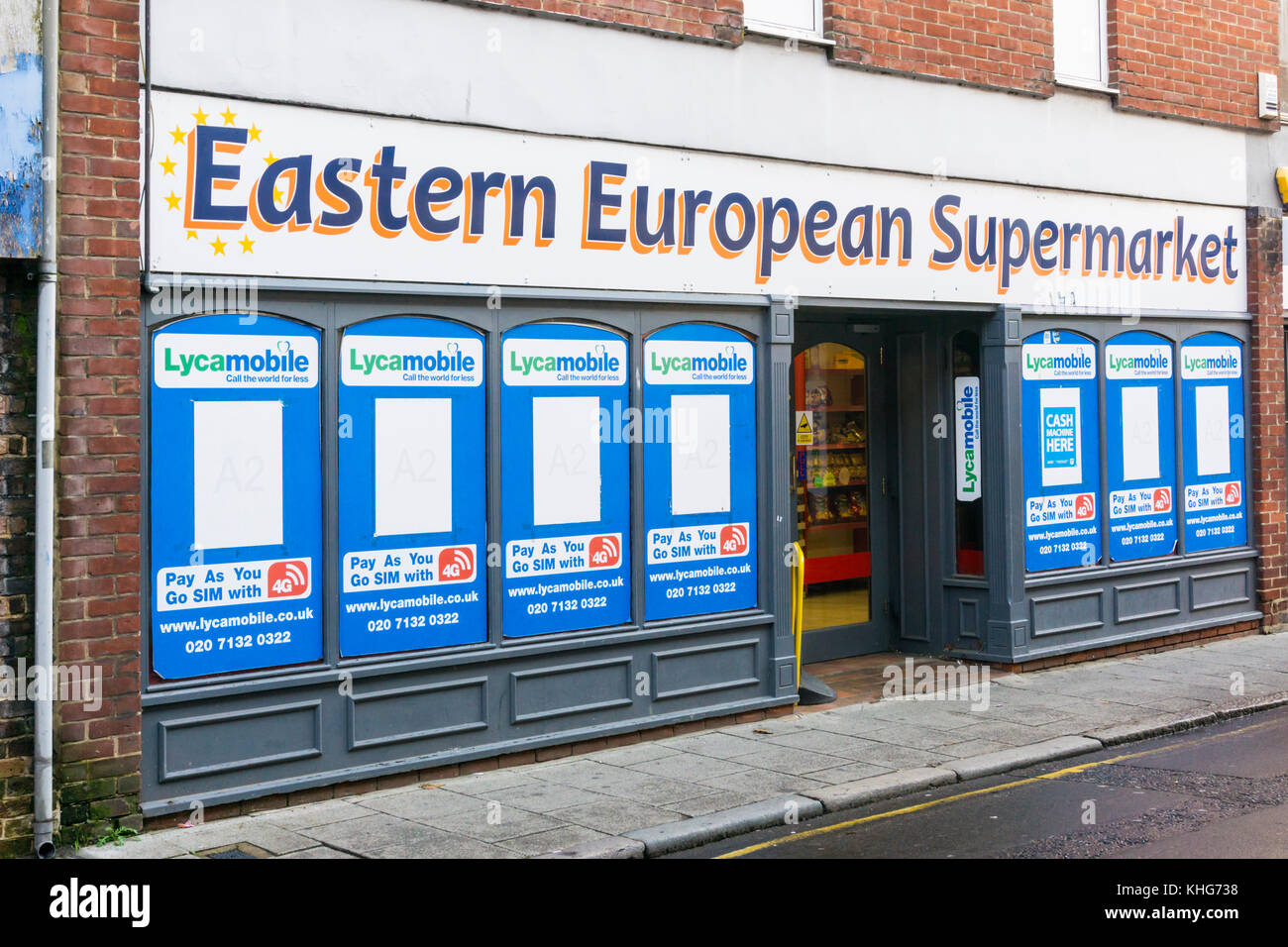 The front of an Eastern European Supermarket in King's Lynn covered with advertisements for Lycamobile Pay As You Go SIM Stock Photo