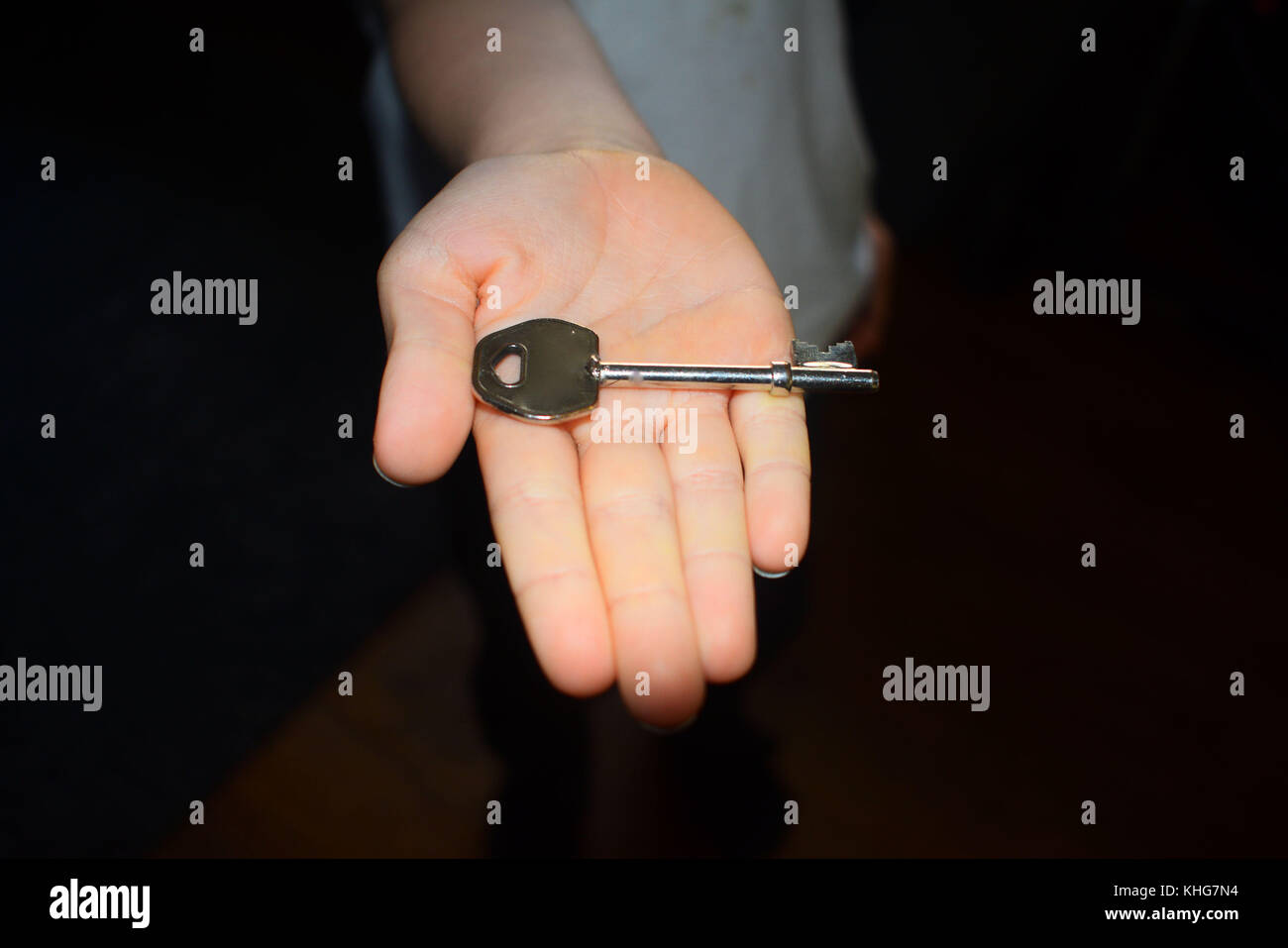 A key in the hand and one for the door Stock Photo