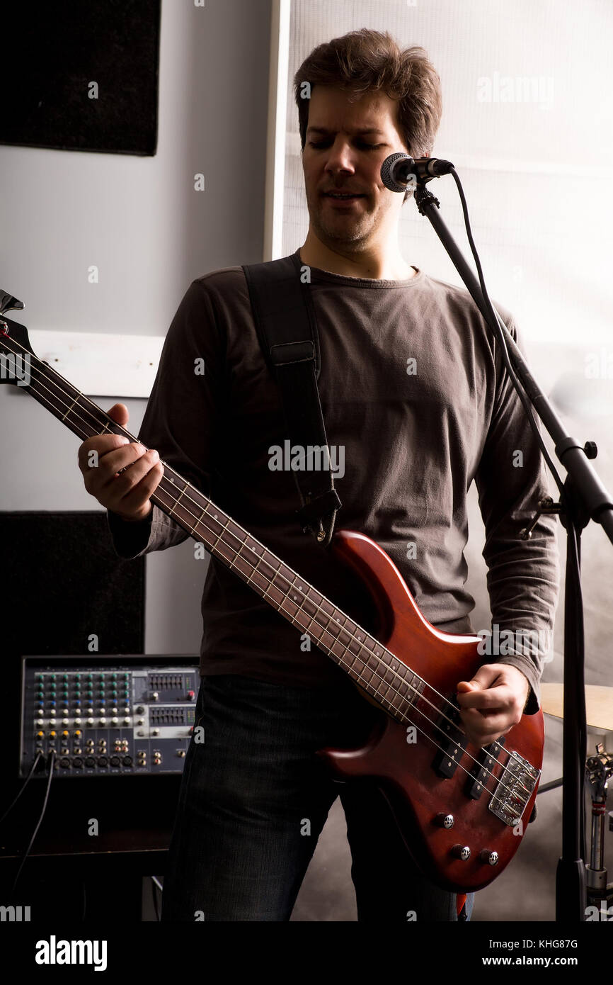 Black and white Portrait of a Rock singer playing bass in the rehearsal
