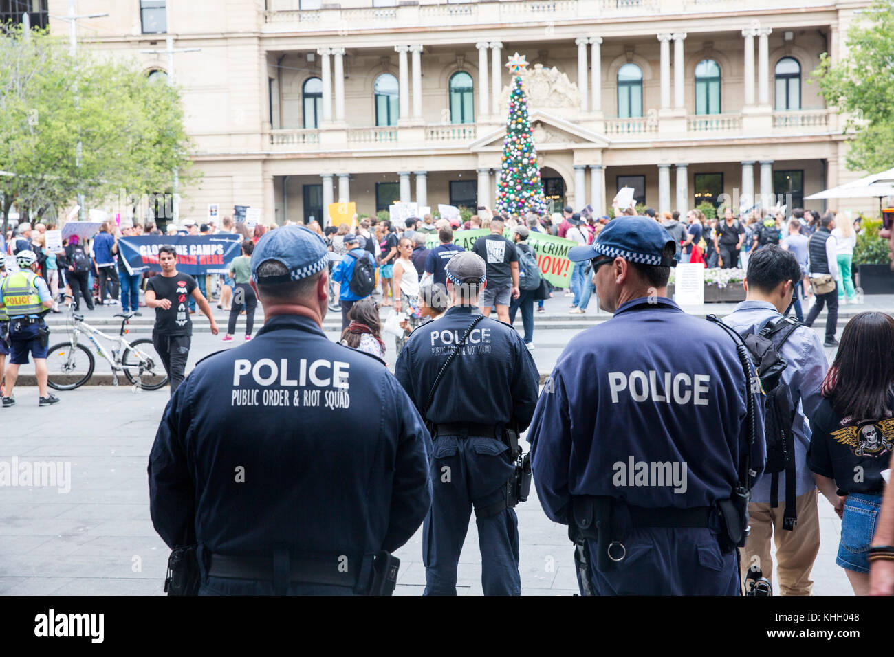 Sydney, Australia.Saturday 18th November 2017. The Refugee Action Colation hold a protest in Circular Quay Sydney seeking the Australian Government to settle refugees in Australia. The New South Wales Police Public Order and Riot squad watch over proceedings. Credit: martin berry/Alamy Live News Stock Photo