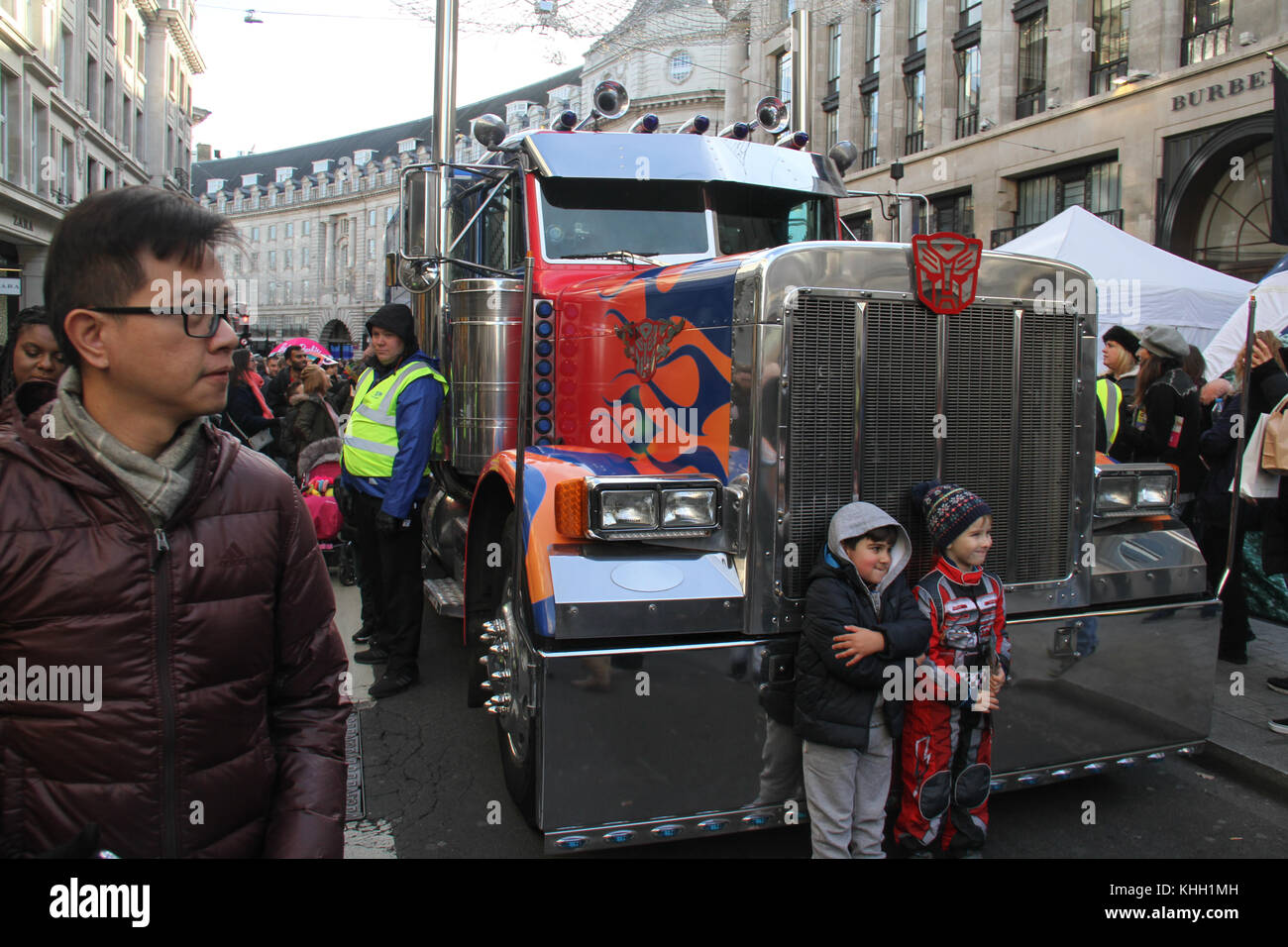 London, UK. 19th Nov 2017.  Two children pose by a Transformer truck at Hamleys Christmas Toy Parade on a traffic-free Regents Street on 19 November. The mile of style was transformed into a traffic-free all-day extravaganza for the biggest Hamleys Toy Parade and ‘Character Meet and Greet'. Credit: david mbiyu/Alamy Live News Stock Photo
