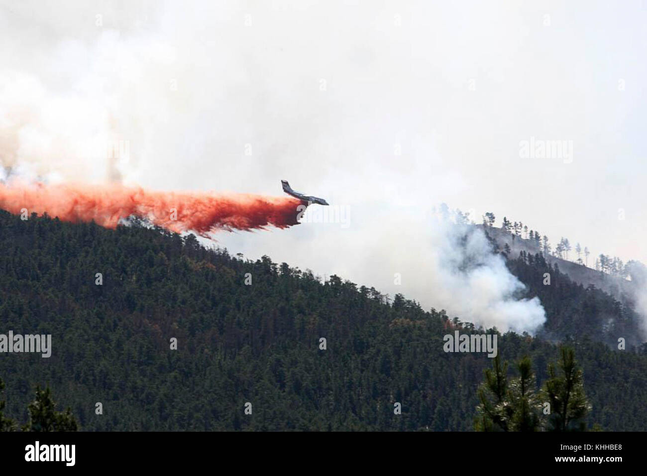 Aircraft drops flame retardant chemical on Crow Peak Fire. The Crow