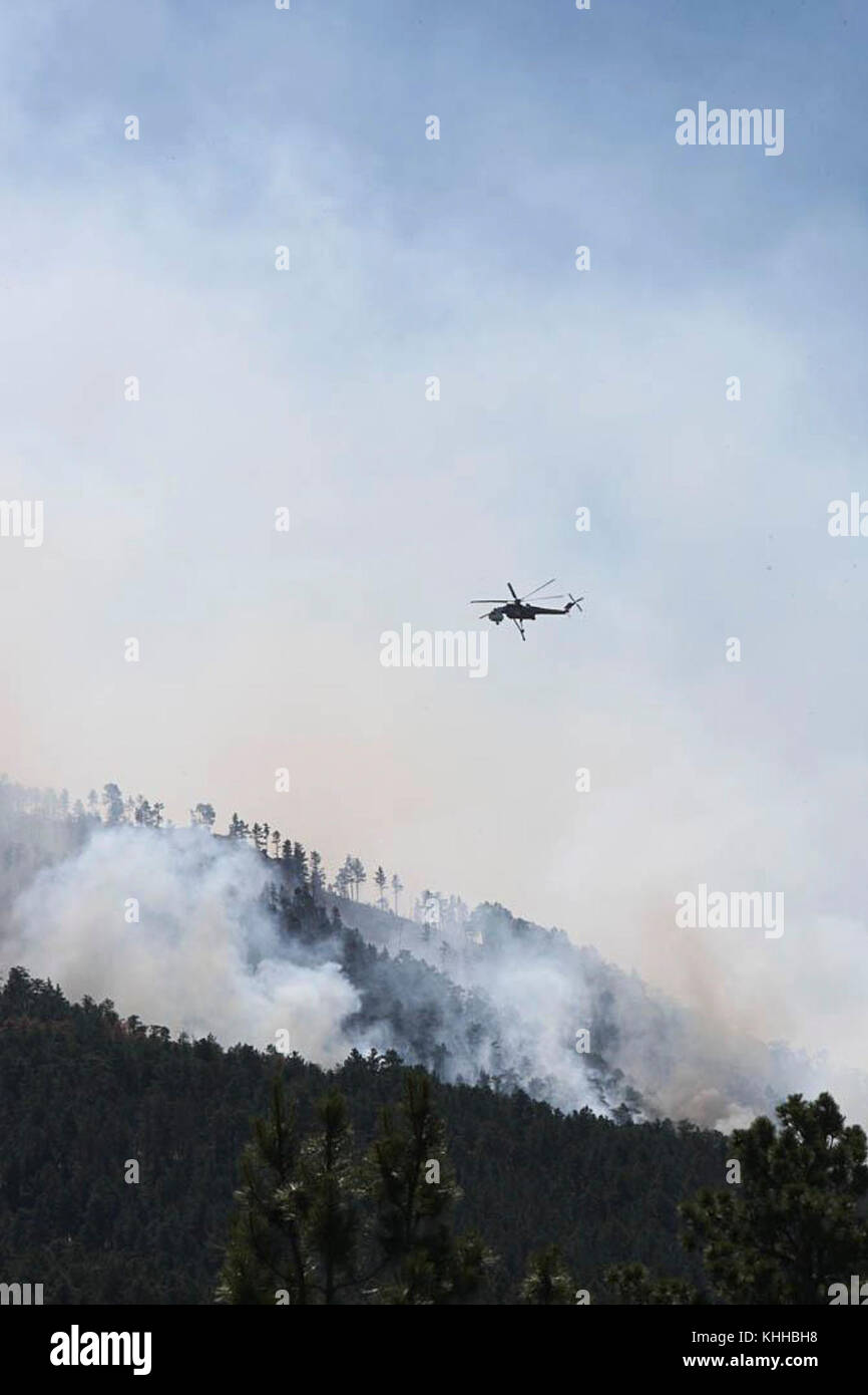 A helicopter prepares to make water drop on the Crow Peak Fire. The Crow Peak Fire located in the Black Hills National Forest near Spearfish, SD began on Jun. 24, 2016 started by lightning.  The Crow Peak Fire has consumed 1,350 acres. U.S. Forest Service photo. Stock Photo