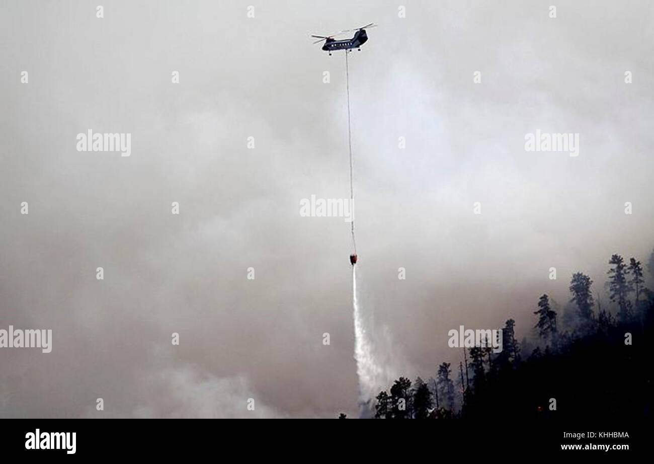 A helicopter makes water drop on the Crow Peak Fire. The Crow Peak Fire