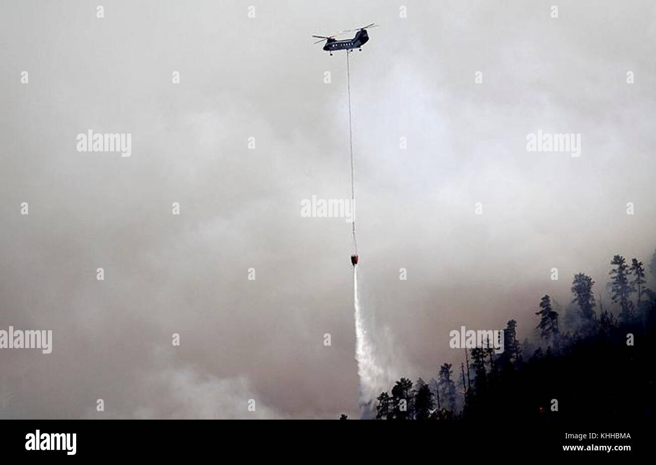 A helicopter makes water drop on the Crow Peak Fire. The Crow Peak Fire located in the Black Hills National Forest near Spearfish, SD began on Jun. 24, 2016 started by lightning.  The Crow Peak Fire has consumed 1,350 acres. U.S. Forest Service photo. Stock Photo
