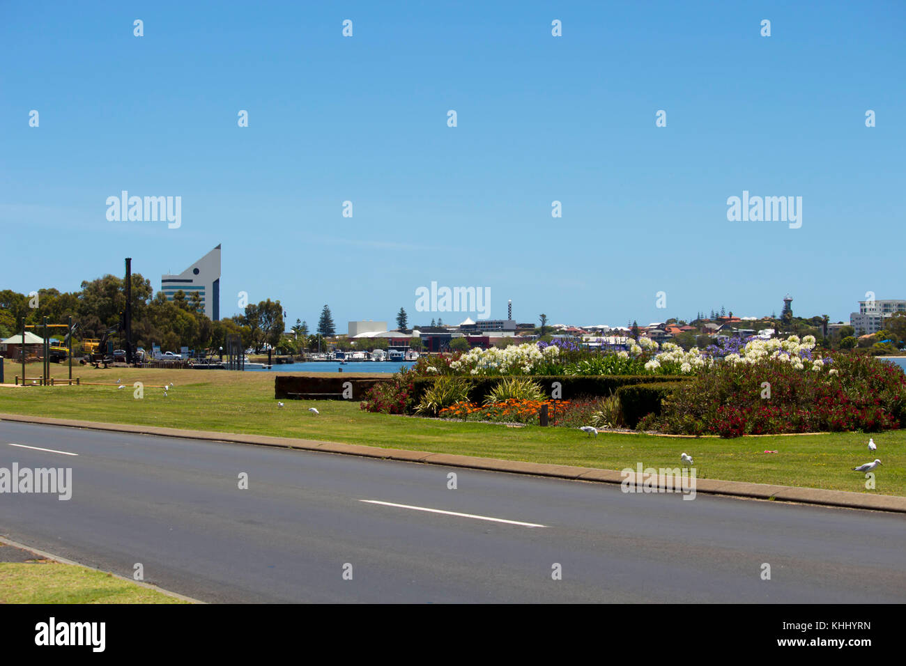 Scenic view of gardens and lawns along Austral Parade  adjoining Leschenault Estuary Bunbury Western Australia with the city in the distance . Stock Photo