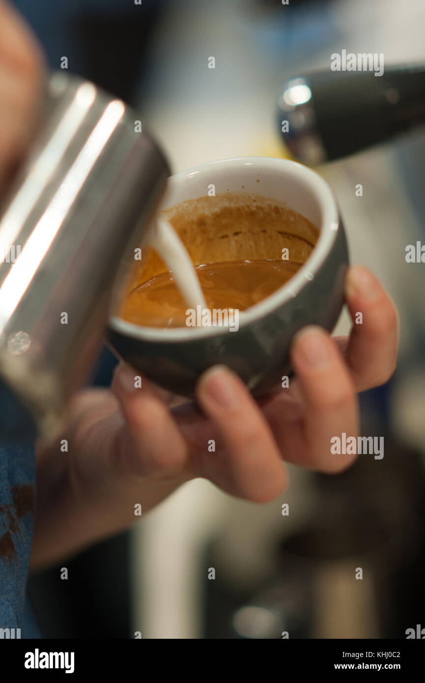 A barista making a cup of coffee Stock Photo