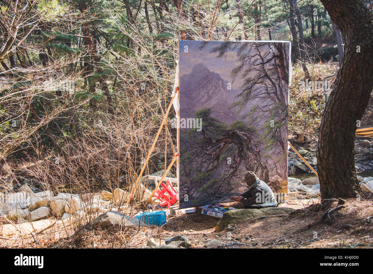 A korean man painting a large landscape picture in Tongdosa, South Korea. Stock Photo