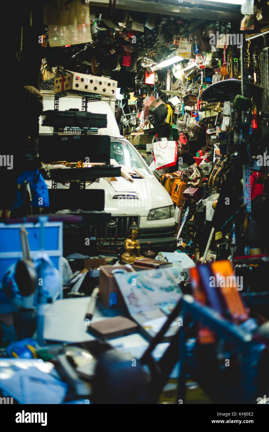 A truck is parked inside a small store selling various wares and knick knacks in Seoul, South Korea. Stock Photo