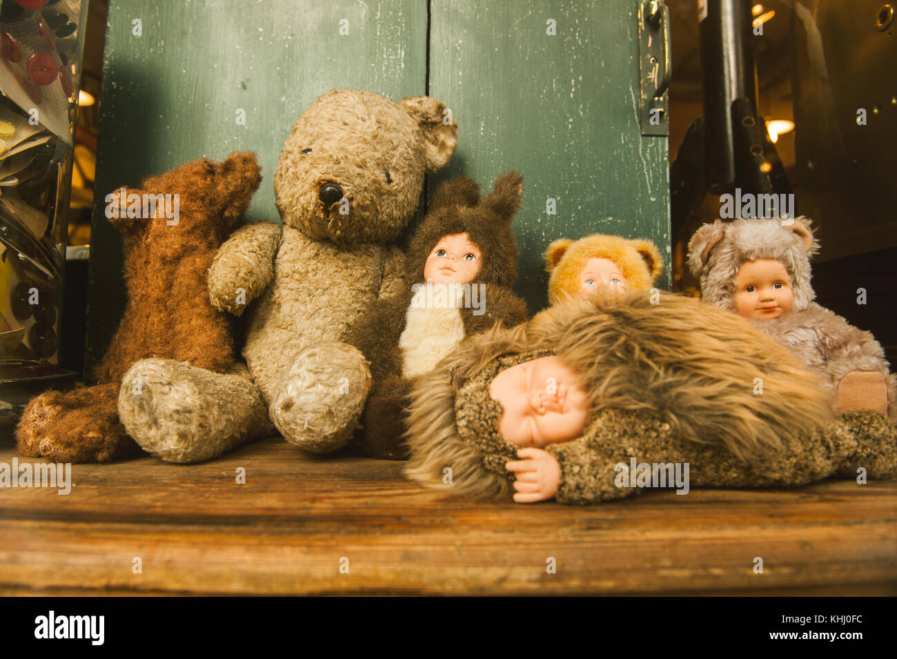 A collection of stuffed toys and dolls on display in an antique store. Stock Photo