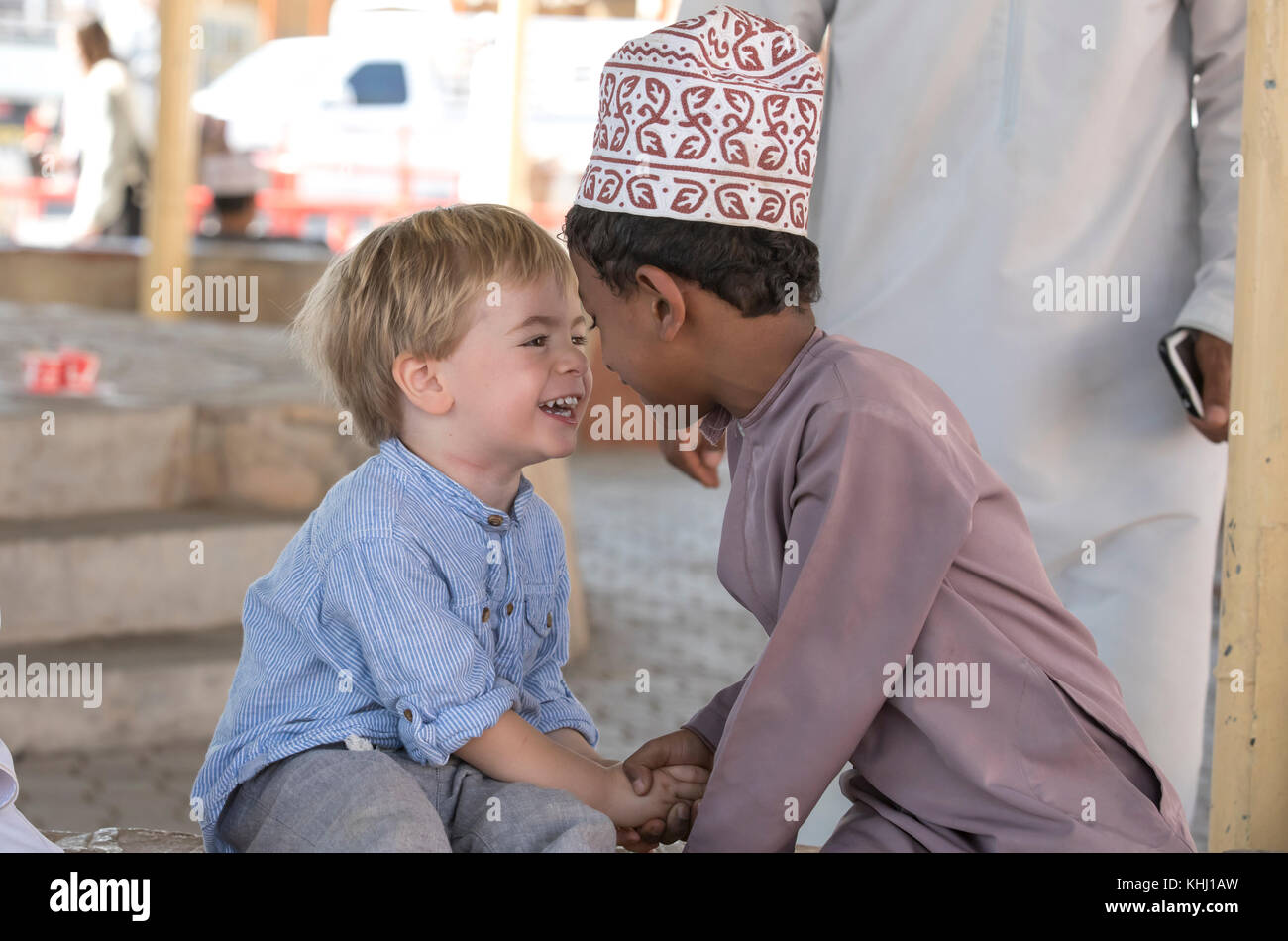 Nizwa, Oman, 10th Nobember 2017: omani kid and european kid giving eachother an eskimo kiss Stock Photo