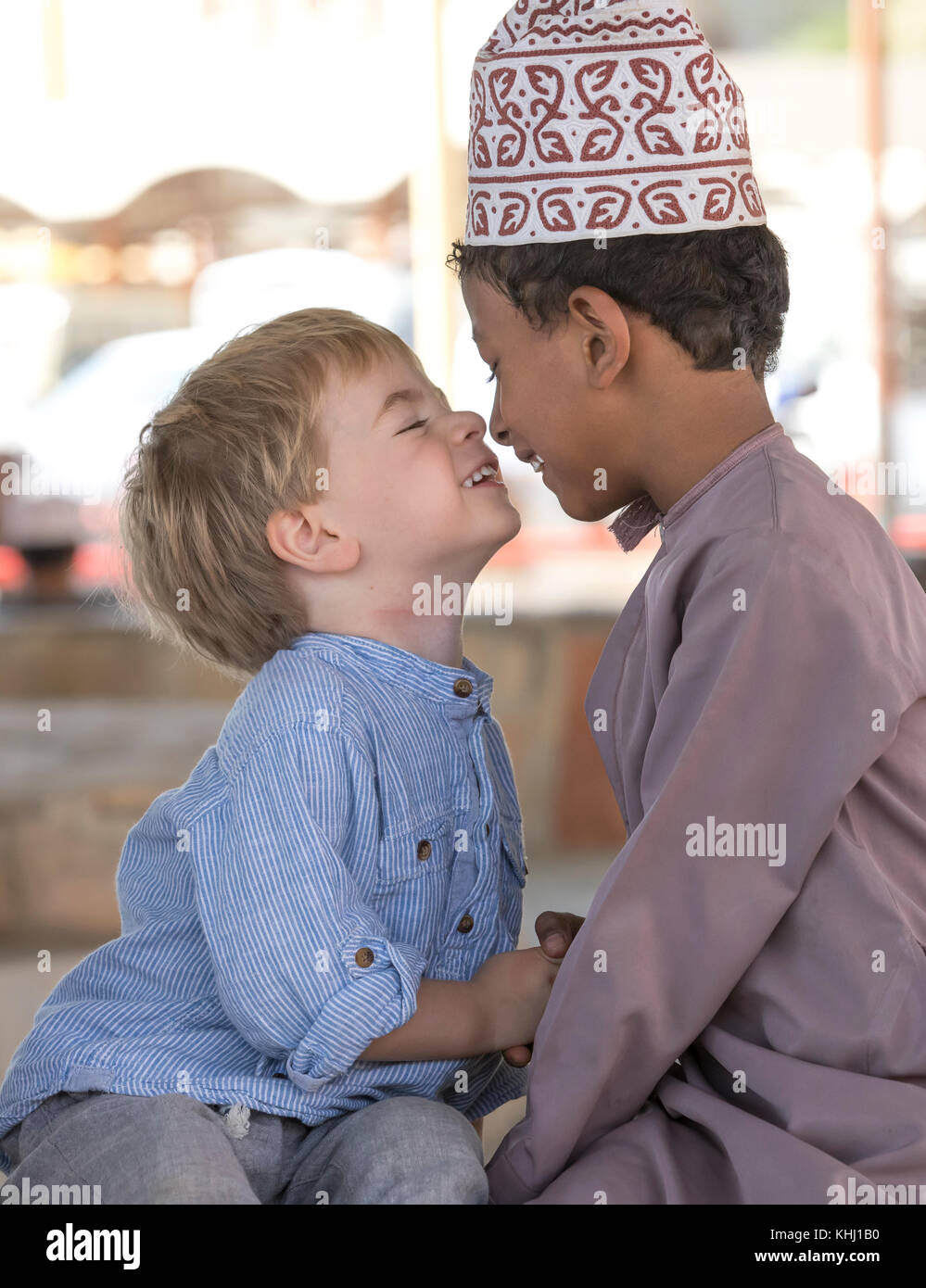 Nizwa, Oman, 10th Nobember 2017: omani kid and european kid giving eachother an eskimo kiss Stock Photo