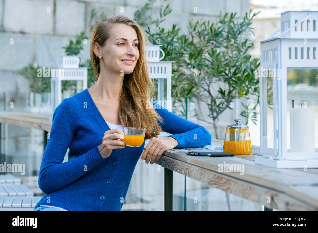 Young pretty woman enjoys cup of tea Stock Photo - Alamy
