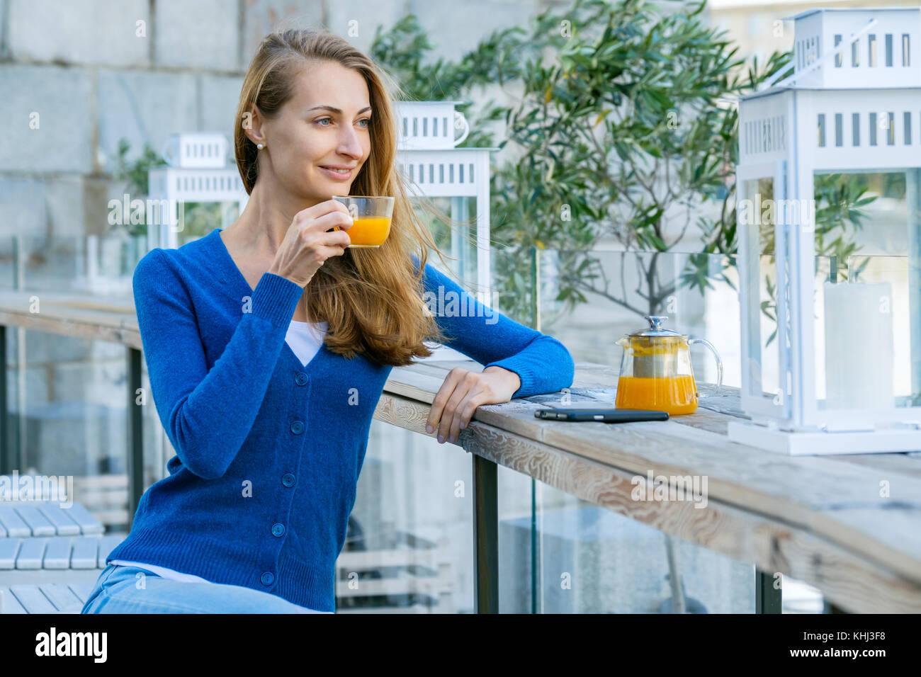 Young pretty woman enjoys cup of tea Stock Photo - Alamy