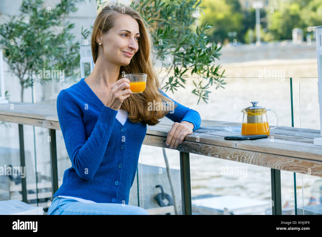 Young pretty woman enjoys cup of tea Stock Photo - Alamy