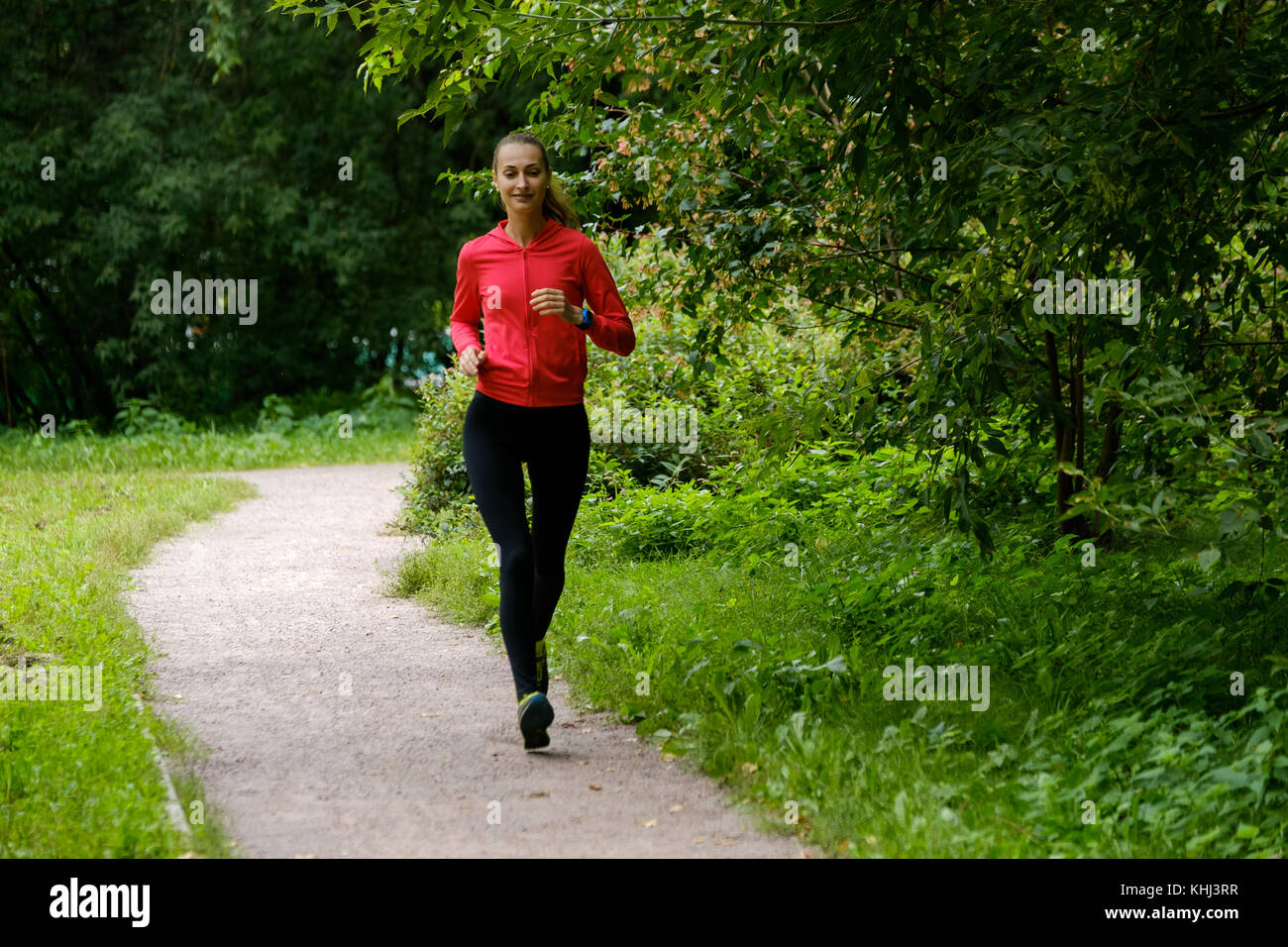 Young woman jogging in the park Stock Photo - Alamy