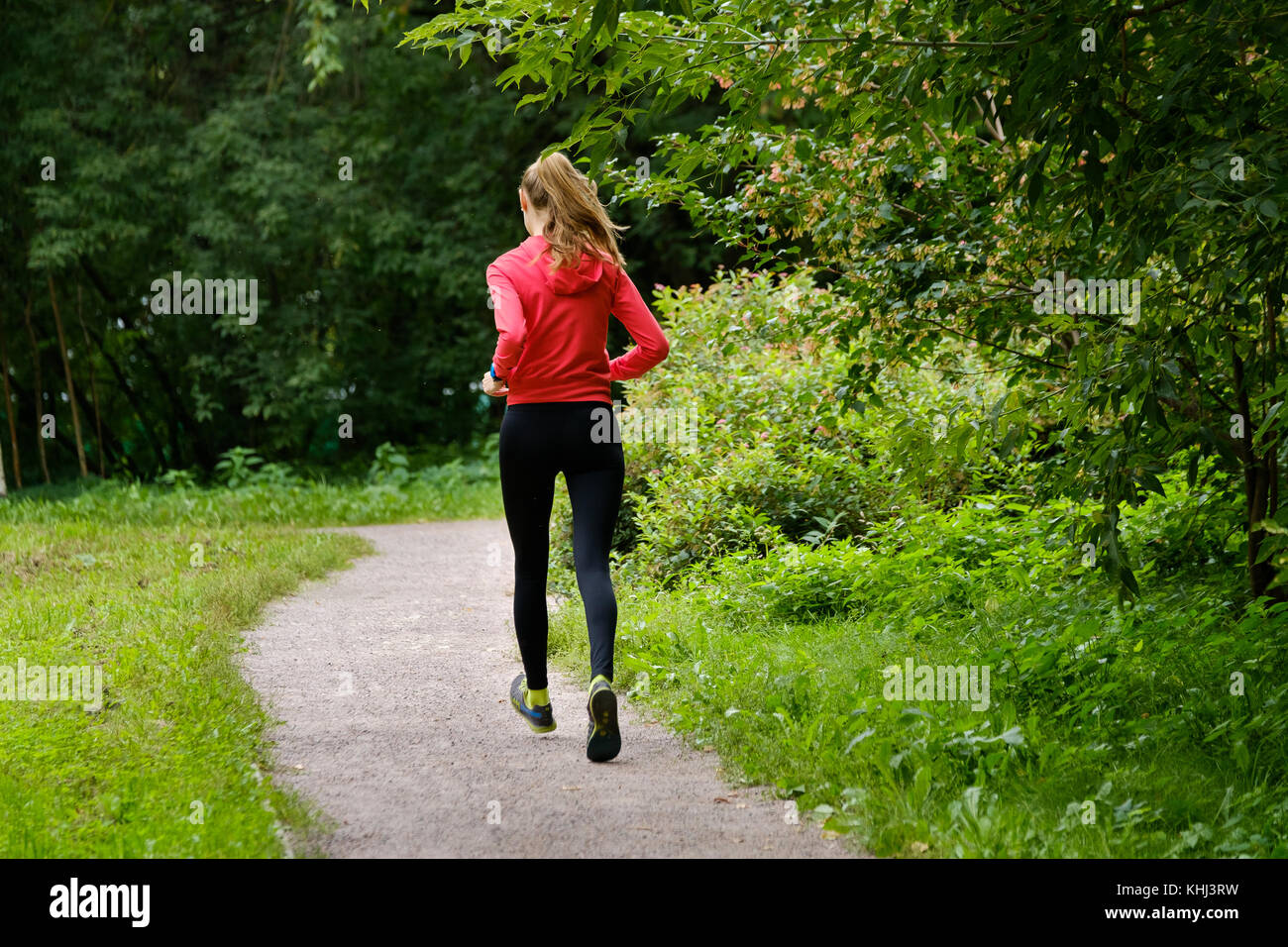 Young woman jogging in the park Stock Photo - Alamy