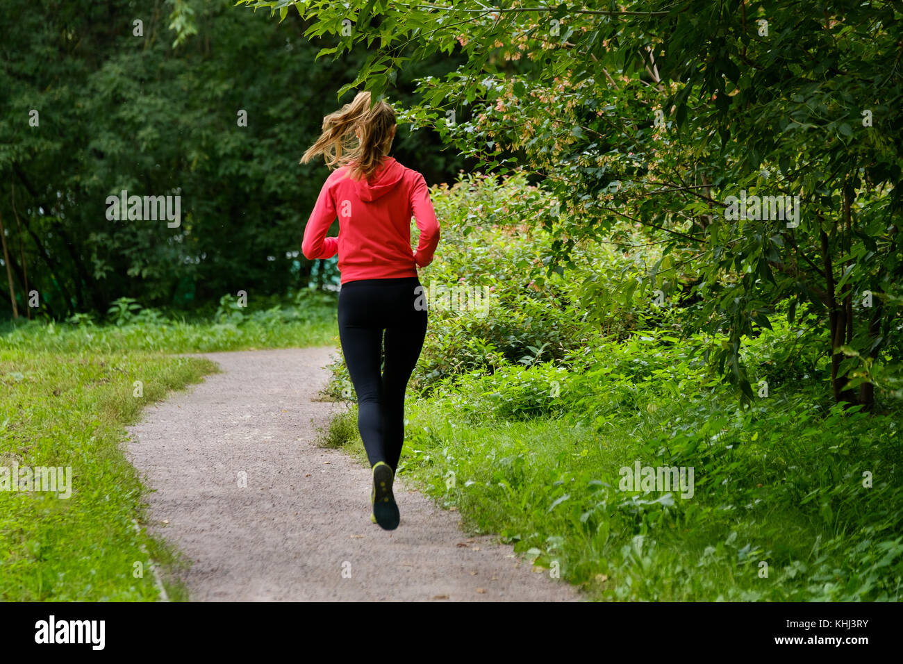 Young woman jogging in the park Stock Photo - Alamy