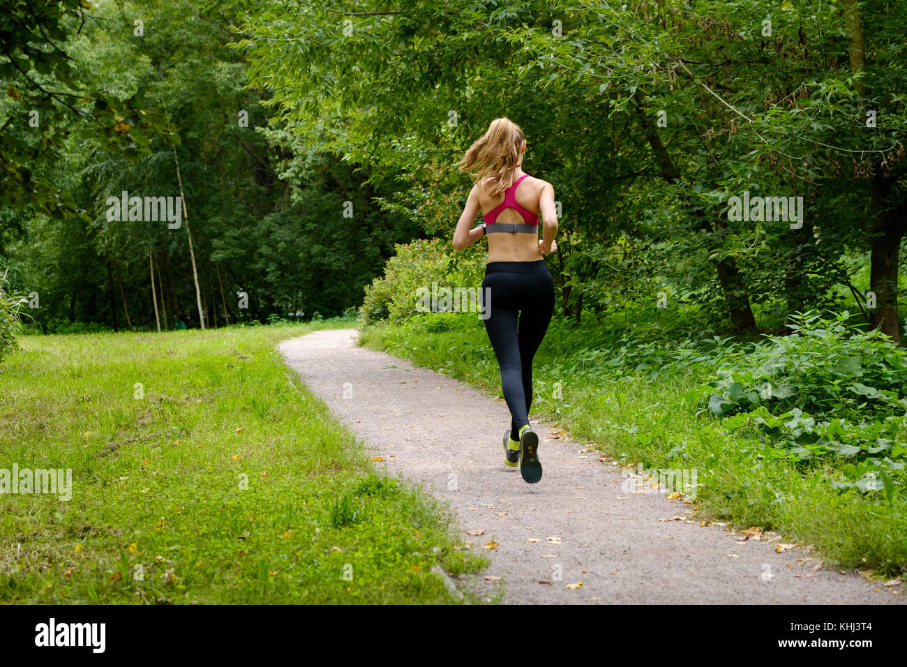 Young woman jogging in the park Stock Photo - Alamy