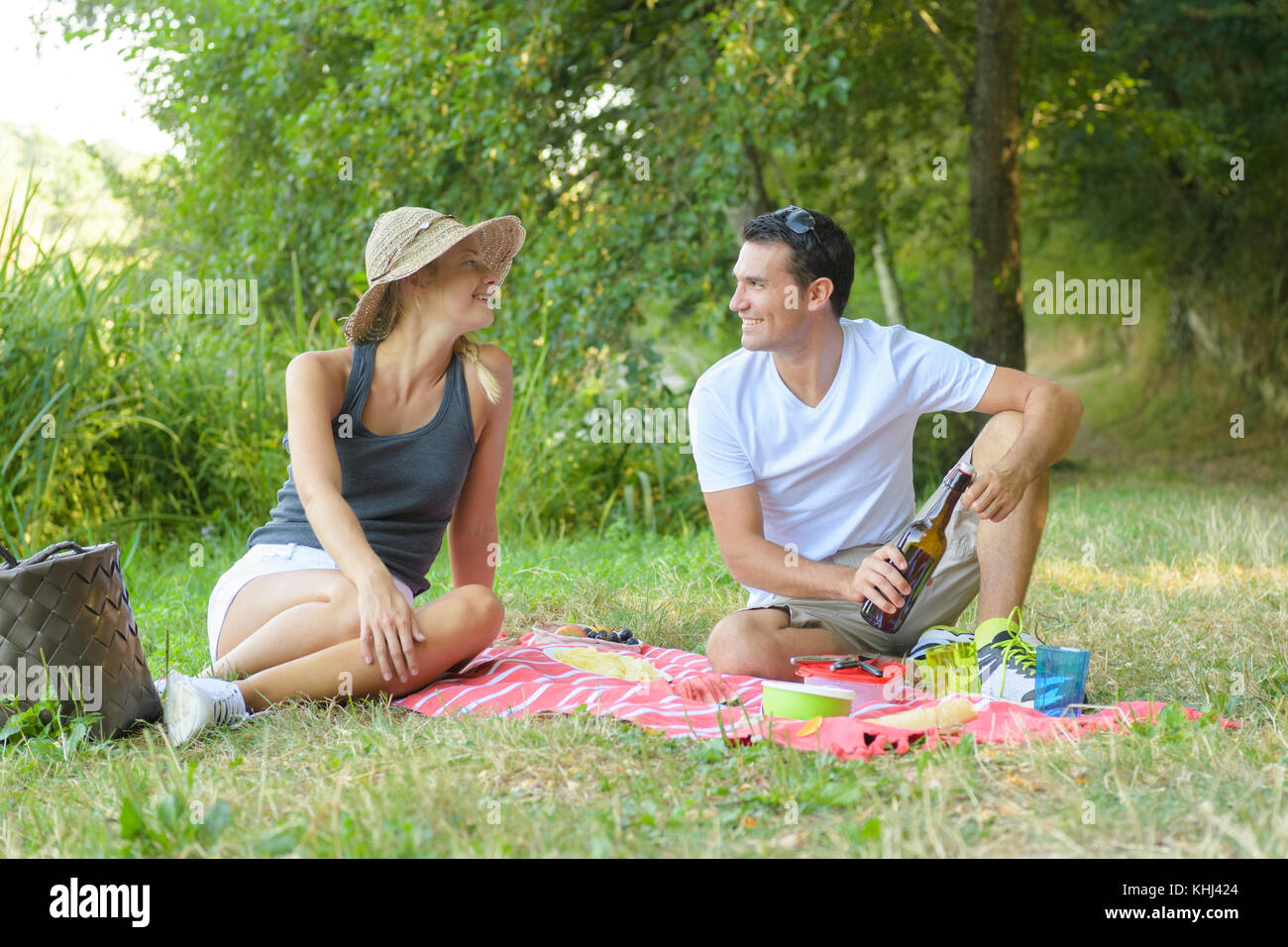 cute young couple drinking red wine on a picnic Stock Photo - Alamy