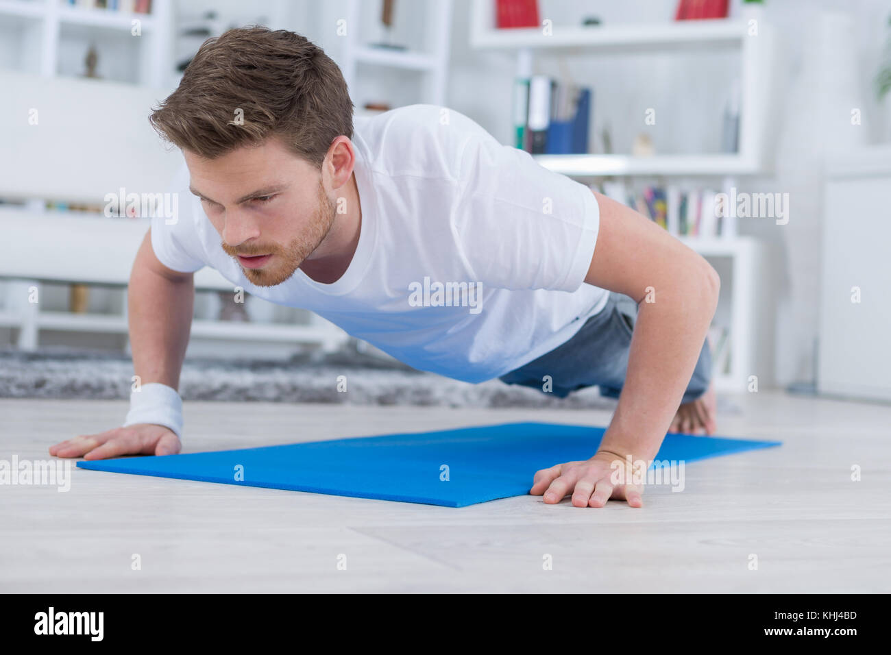 young fit guy doing push ups in the living room Stock Photo - Alamy