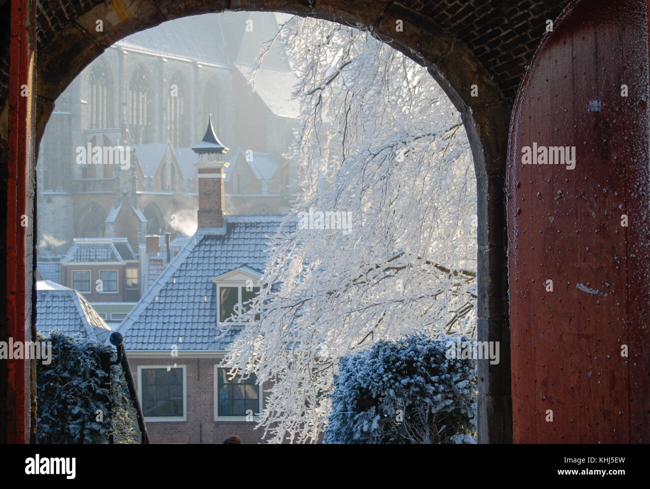 View onto covered with fresh new snow town and historic buildings from medieval gate Stock Photo