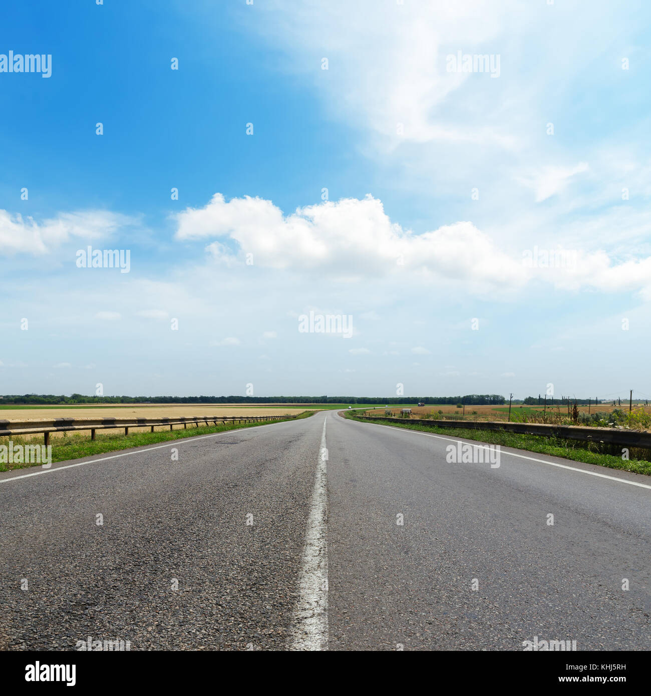 cloudy sky over asphalt road Stock Photo - Alamy