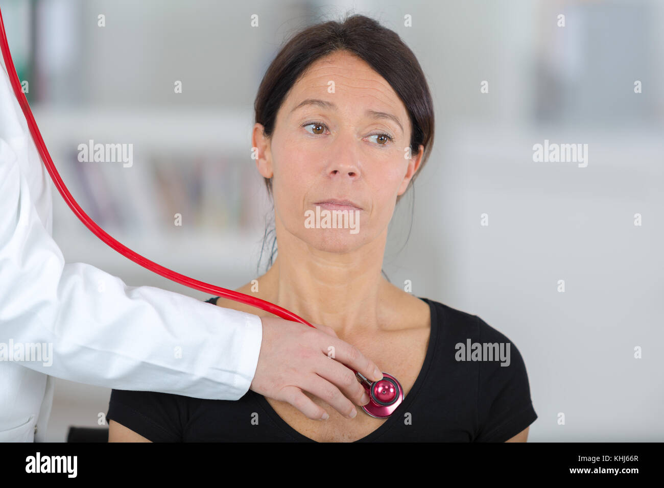 doctor female listening heartbeat of patient with stethoscope Stock ...