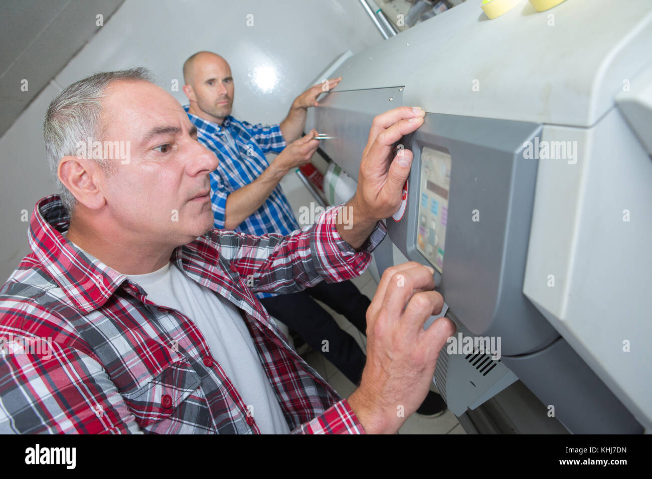 technician setting the program on the machine Stock Photo - Alamy