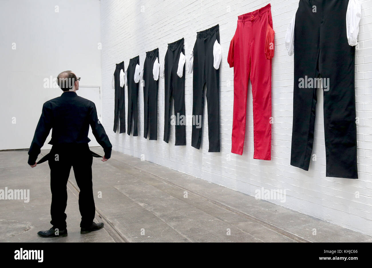 A series of XXXXXXL pairs of trousers with their pockets flung out at the Tramway Arts Centre in Glasgow, which is part of an exhibit by Los Angeles-based artist Amanda Ross-Ho, and forms part of an installation meant to represent a factory floor. Stock Photo