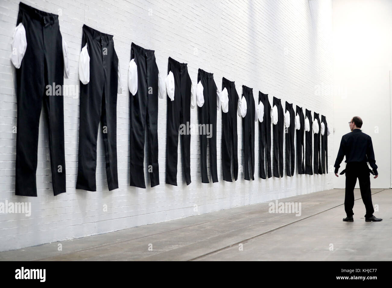 A series of XXXXXXL pairs of trousers with their pockets flung out at the Tramway Arts Centre in Glasgow, which is part of an exhibit by Los Angeles-based artist Amanda Ross-Ho, and forms part of an installation meant to represent a factory floor. Stock Photo