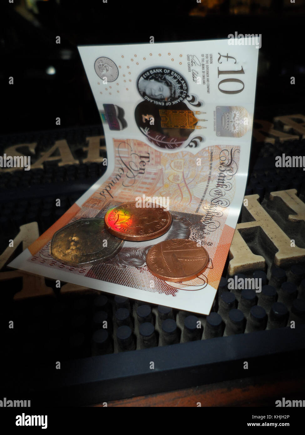 British ten pound note with change resting on a bar mat in an English