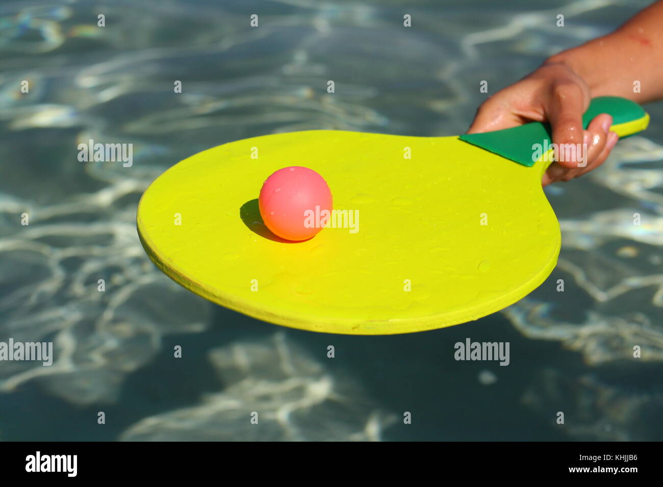 A ball and a racket in the water, to play paddle or beach ball fun game