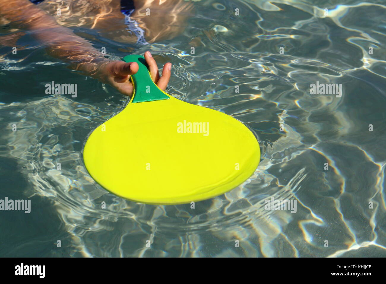A ball and a racket in the water, to play paddle or beach ball fun game