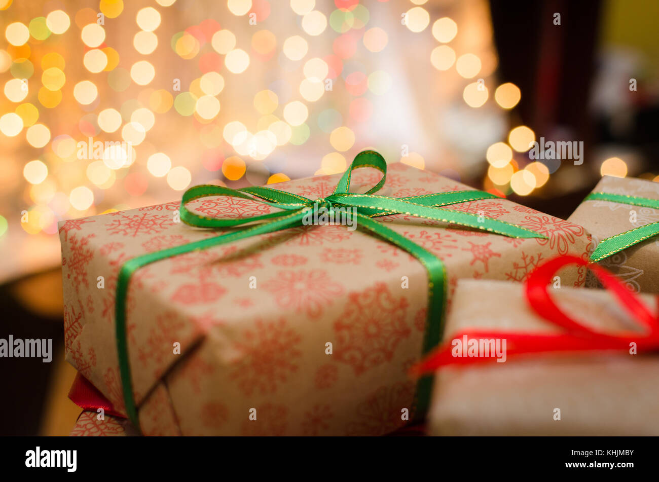 christmas gift boxes wrapped in themed craft paper and satin red and ...