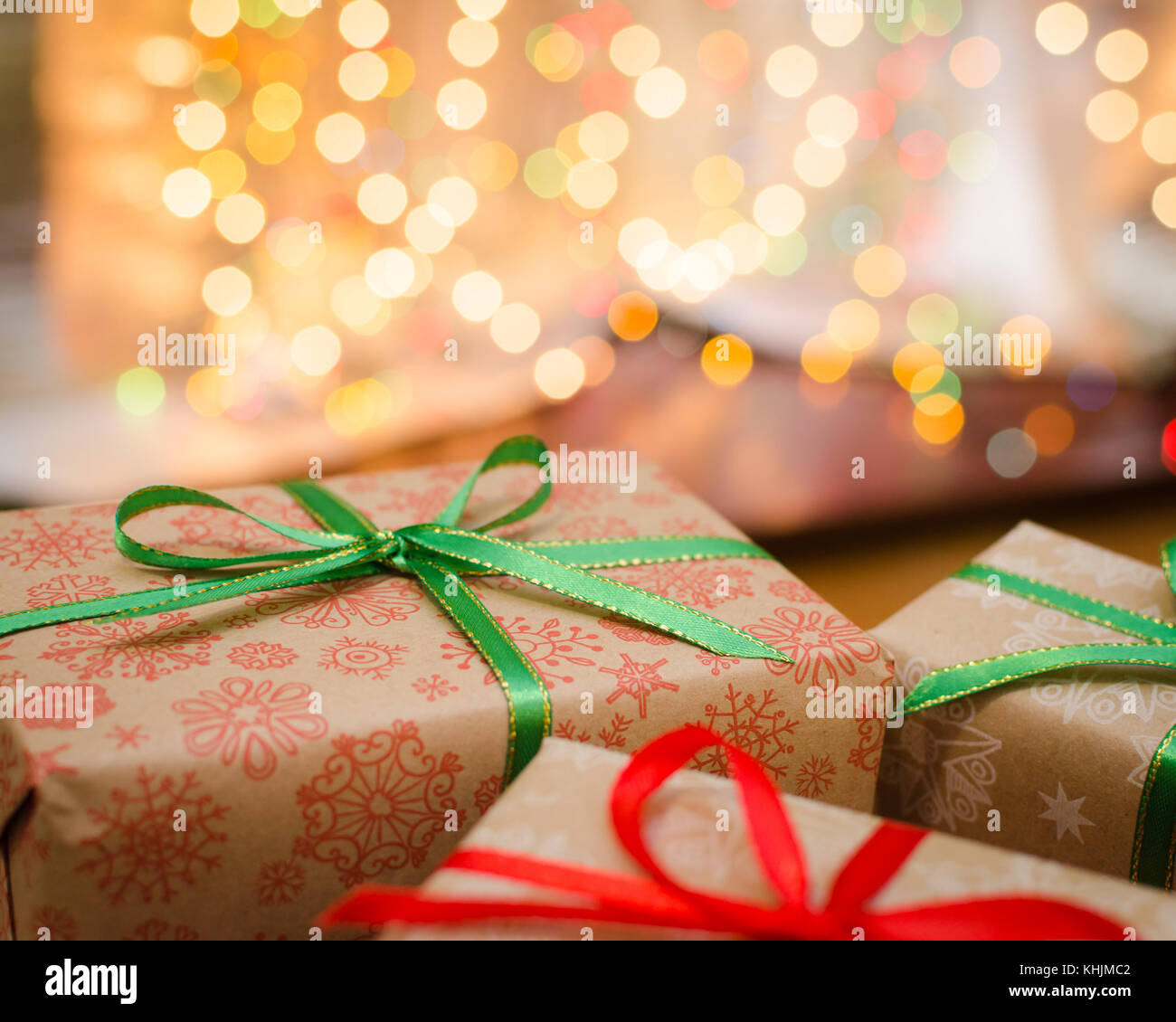 christmas gift boxes wrapped in themed craft paper and satin red and ...