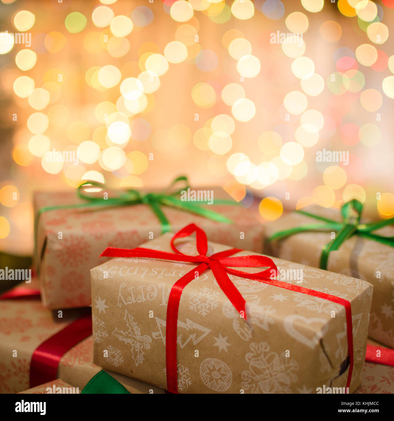 christmas gift boxes wrapped in themed craft paper and satin red and ...