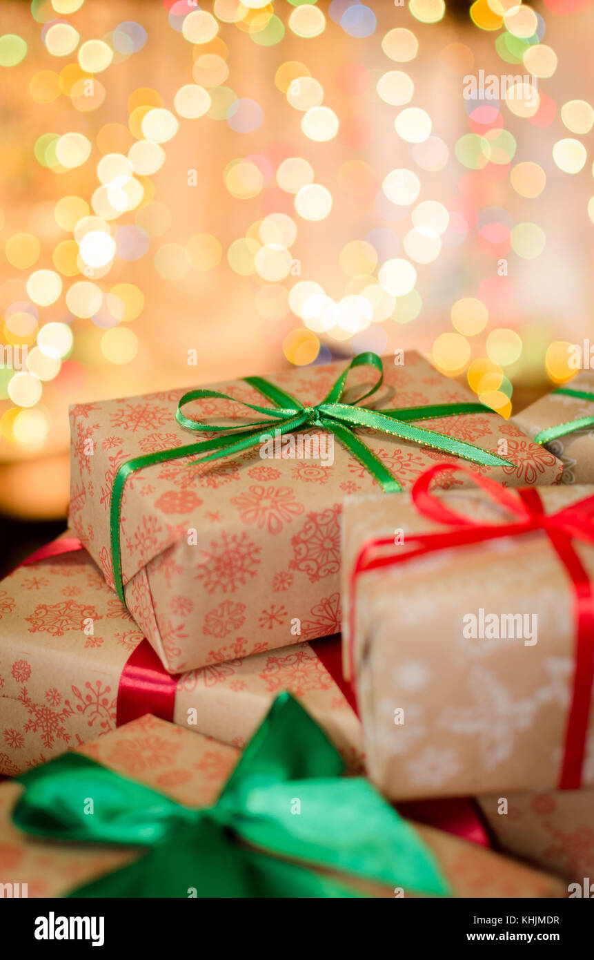 christmas gift boxes wrapped in themed craft paper and satin red and ...
