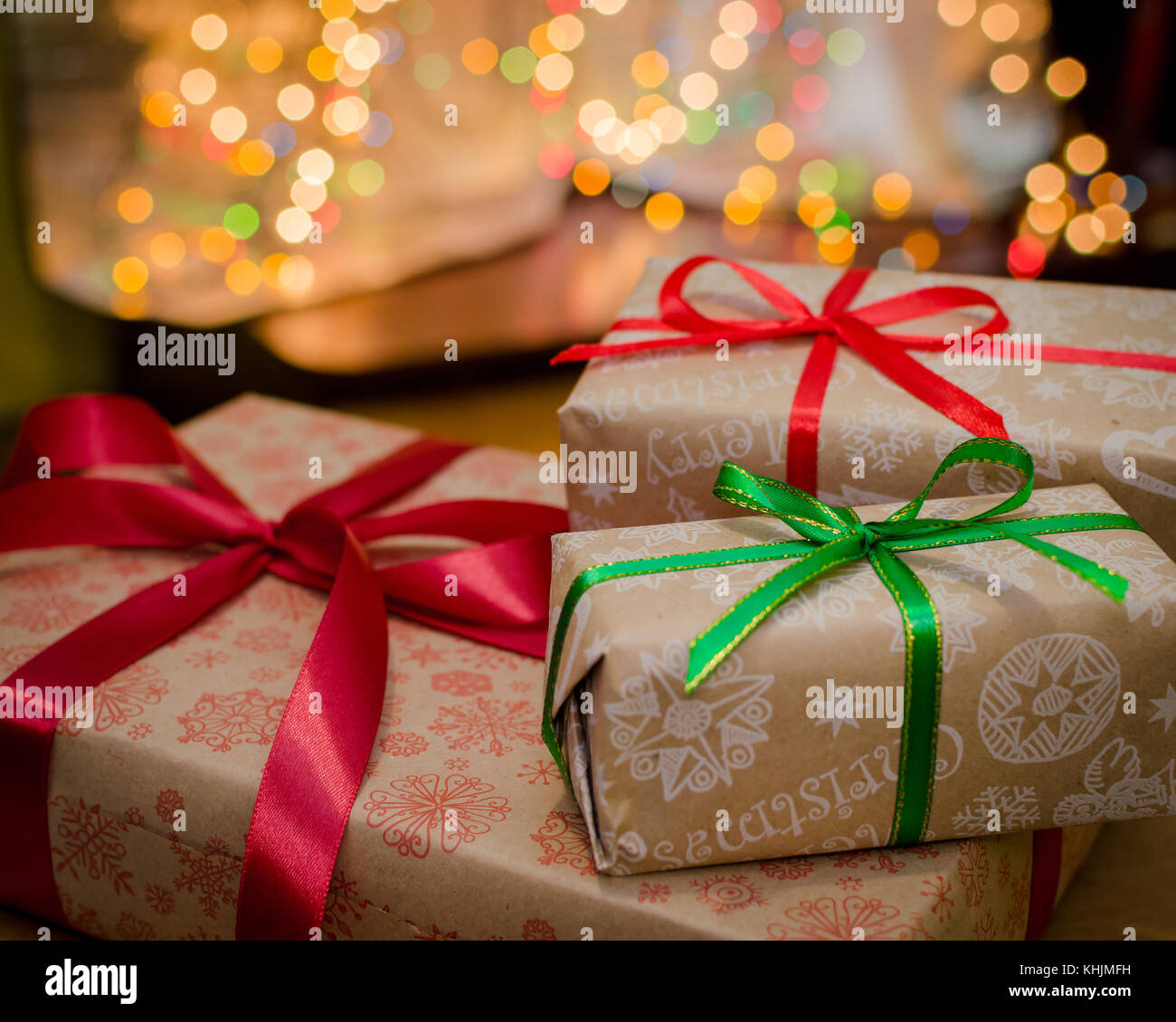 christmas gift boxes wrapped in themed craft paper and satin red and ...
