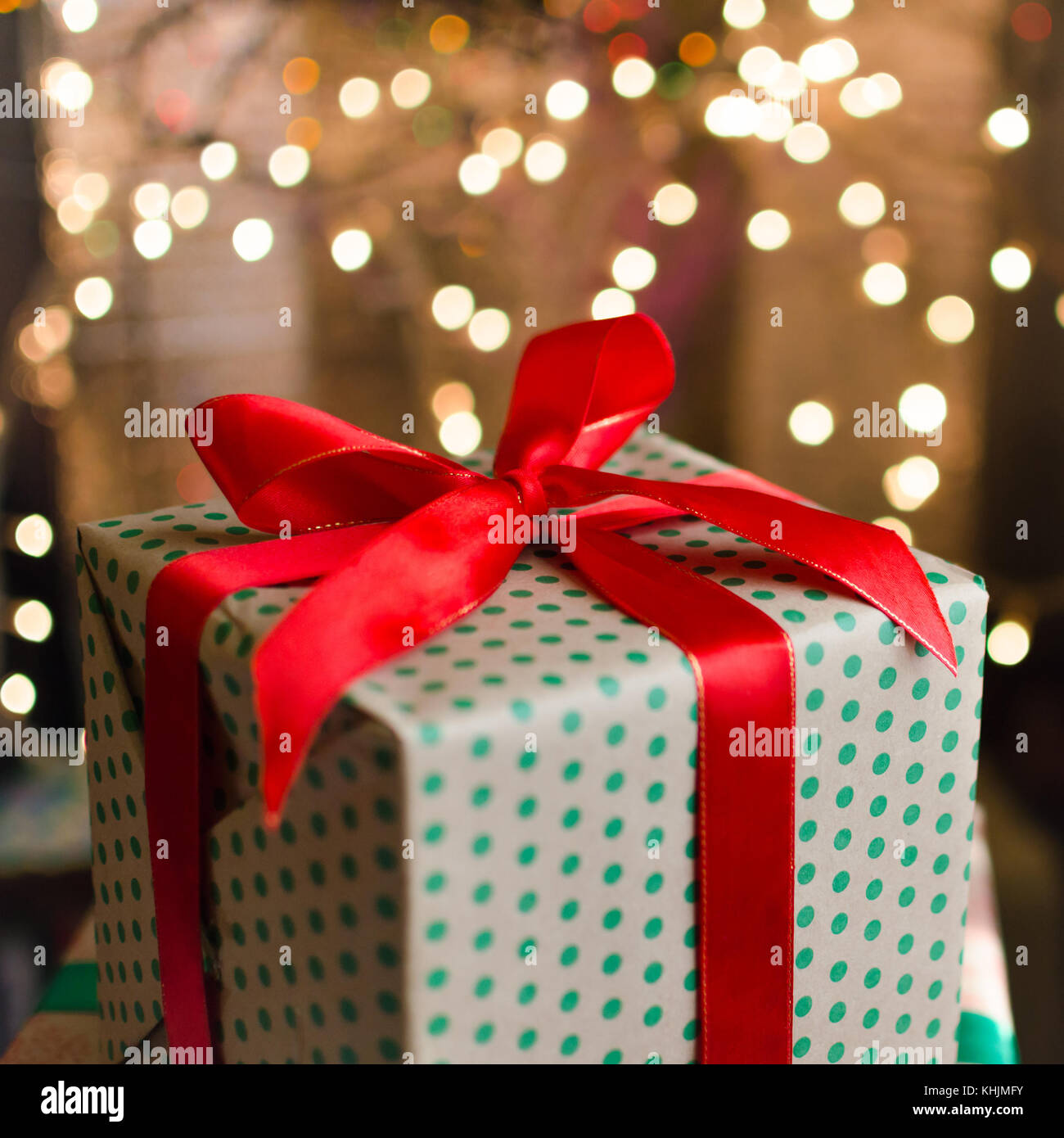 christmas gift boxes wrapped in themed craft paper and satin red bow ...