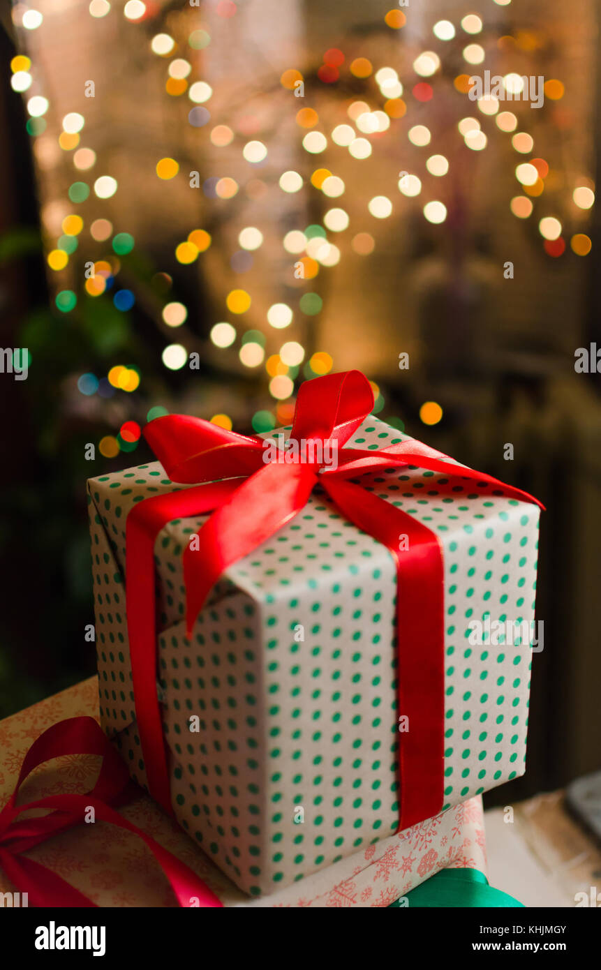 christmas gift boxes wrapped in themed craft paper and satin red bow