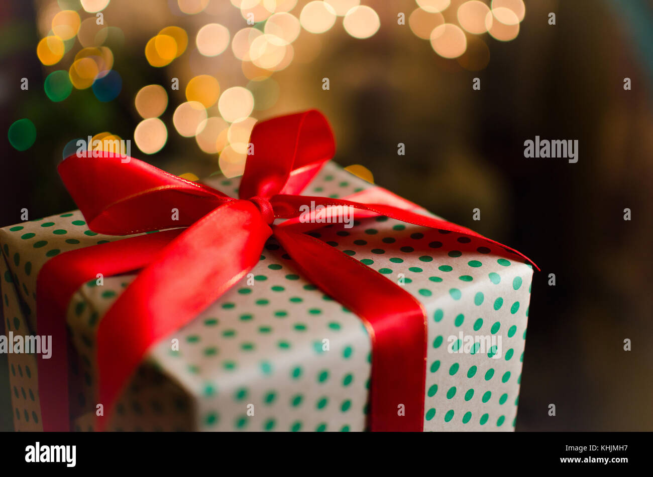 christmas gift boxes wrapped in themed craft paper and satin red bow ...