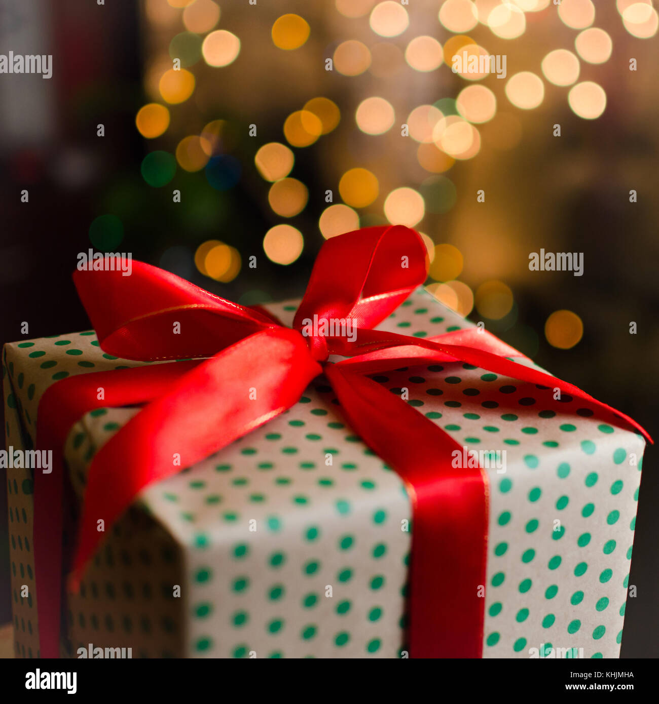 christmas gift boxes wrapped in themed craft paper and satin red bow ...