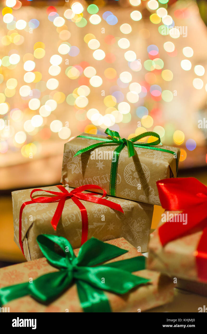 christmas gift boxes wrapped in themed craft paper and satin red and ...