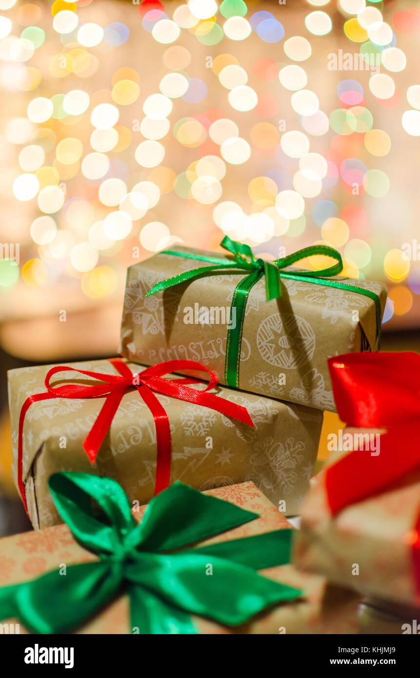 christmas gift boxes wrapped in themed craft paper and satin red and ...