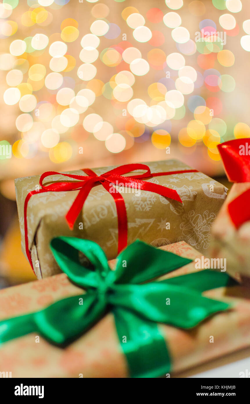 christmas gift boxes wrapped in themed craft paper and satin red and ...