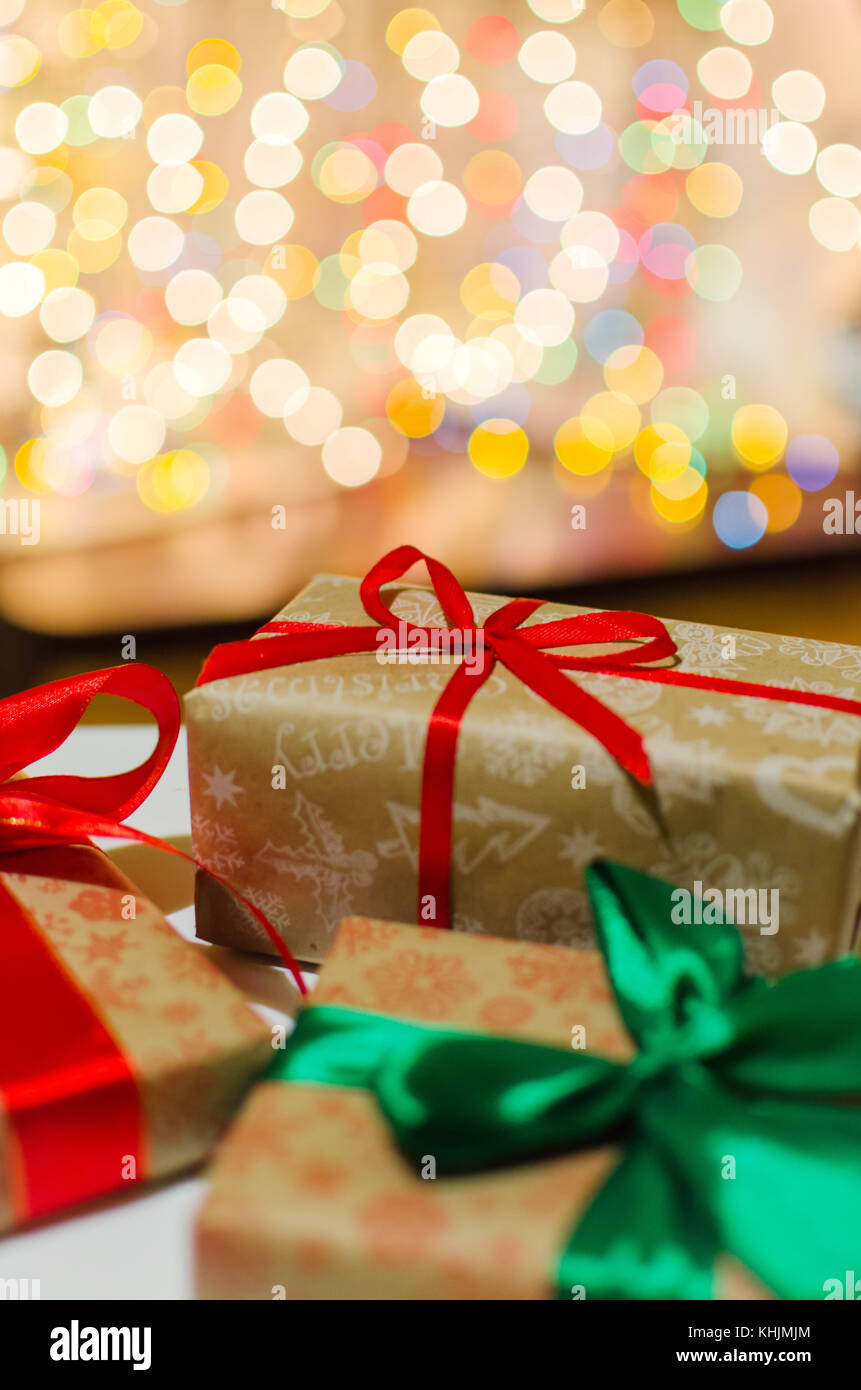 christmas gift boxes wrapped in themed craft paper and satin red and ...