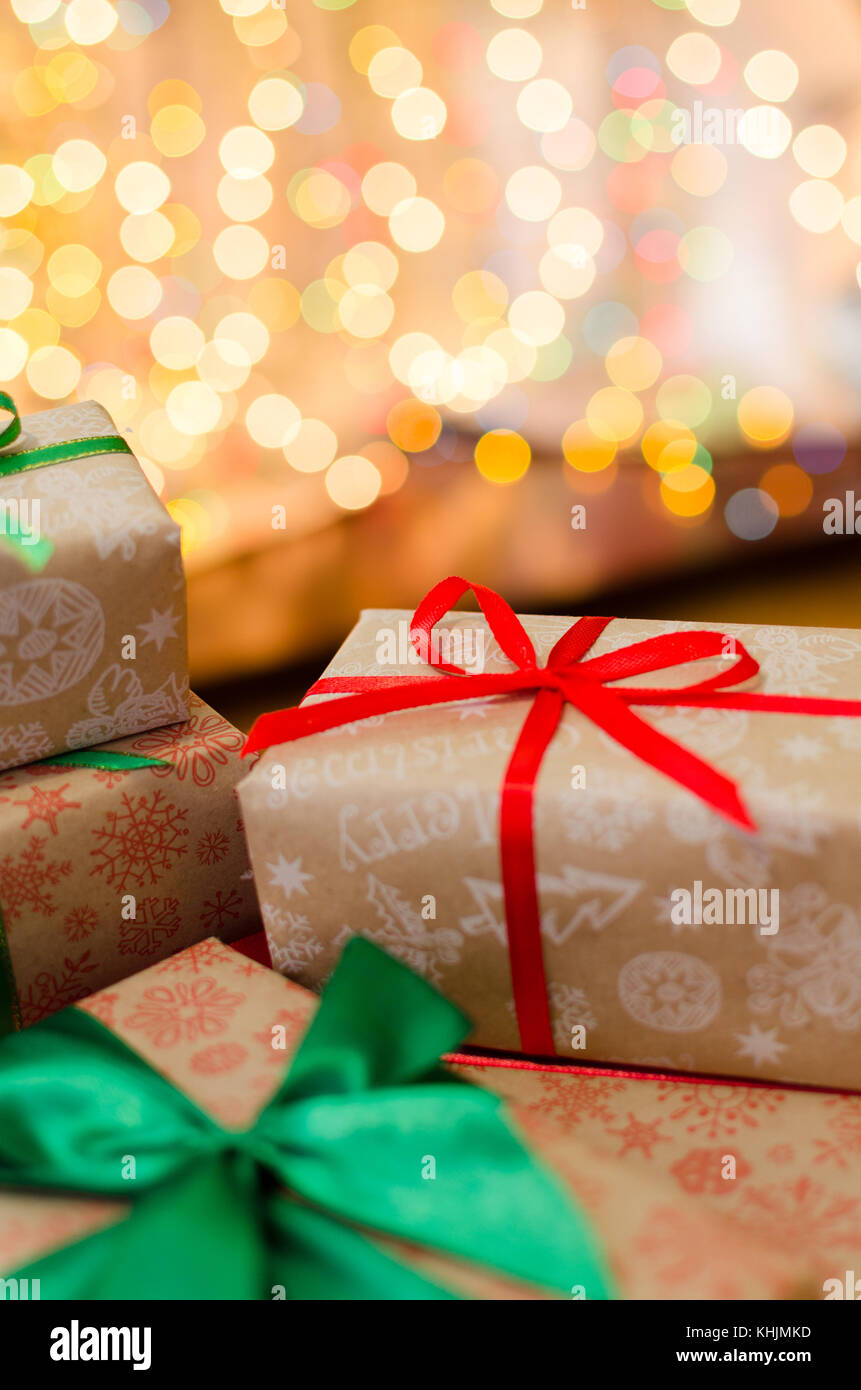 christmas gift boxes wrapped in themed craft paper and satin red and ...