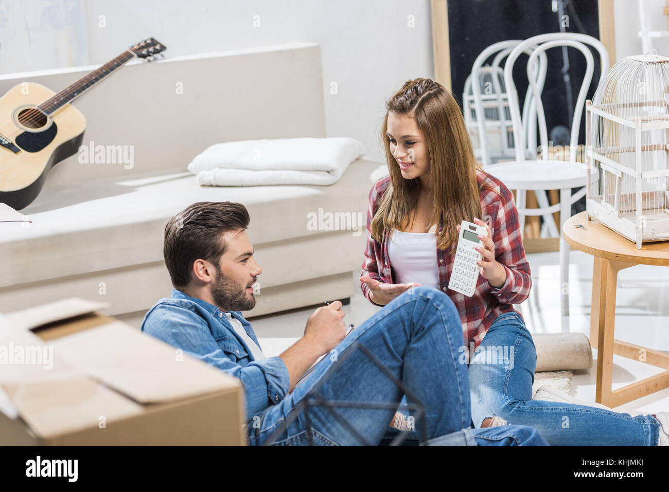 Young couple using calculator Stock Photo Alamy